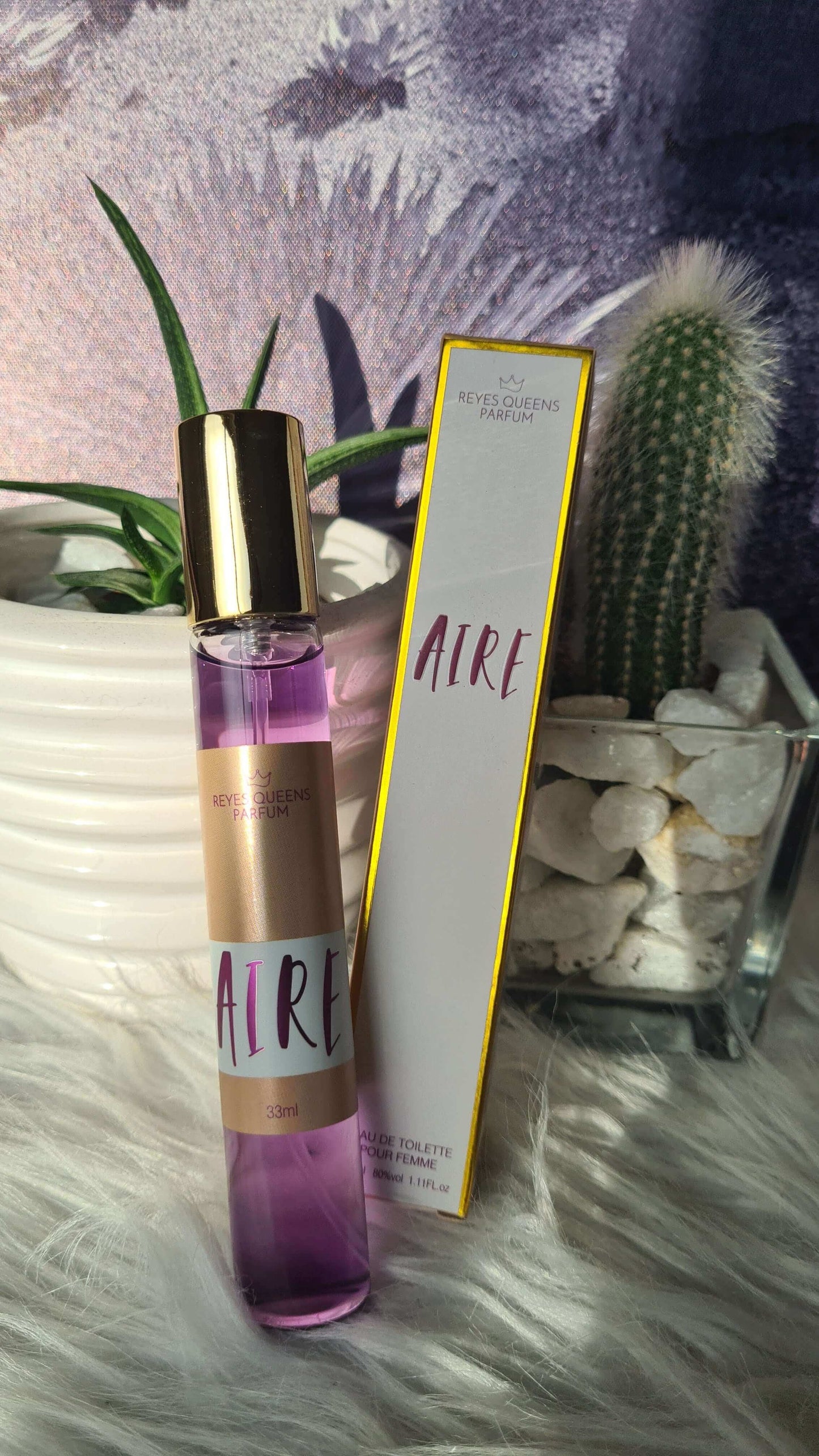 "Aire Eau de Toilette by Reyes Queen 33ml with Jasmine, Woody Amber Scent, shown in pink bottle and elegant packaging"